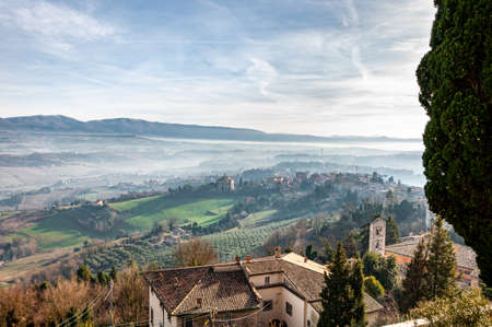 Todi in Umbria, Italy. Panorama from the hill on which the medieval city rises, from the valley of the middle course of the Tiber river, which flows towards Orvieto and Rome.の写真素材