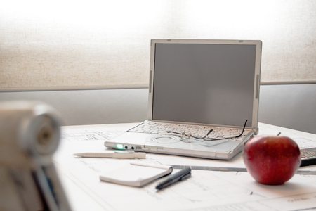 computer desk, glasses, note pad and an appleのeditorial素材