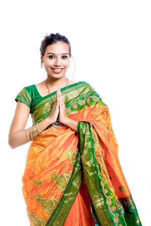 Happy young beautiful Indian woman in traditional saree with giftの写真素材