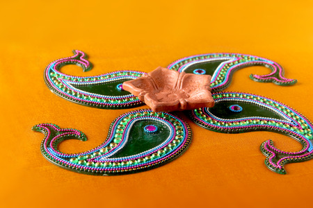 Rangoli design around Diwali lampの写真素材