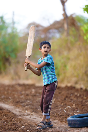 Rural Indian Child Playing Cricketの写真素材