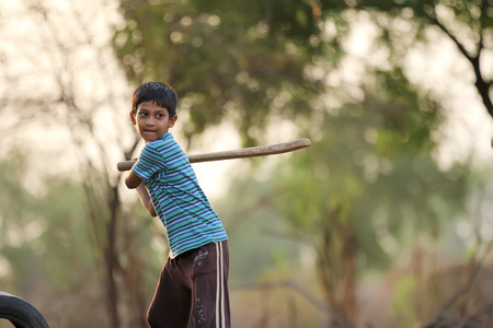 Rural Indian Child Playing Cricketの写真素材