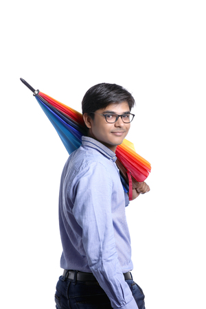 young indian man with umbrellaの写真素材