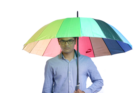 young indian man with umbrellaの写真素材