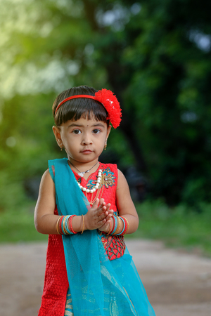 Little Indian girl child with lord ganesha and praying , Indian ganesh festivalの写真素材