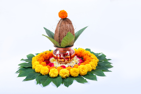 Copper Kalash with coconut , leaf and floral decoration on a white background. essential in hindu puja.の写真素材
