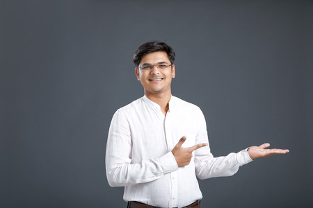 Indian young man showing direction with handの写真素材