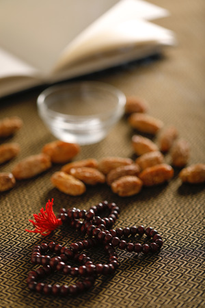 Date fruits with Islamic prayer beads on an artistic background.の写真素材