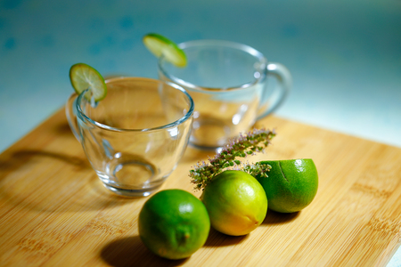 Empty glass cups with limeの写真素材