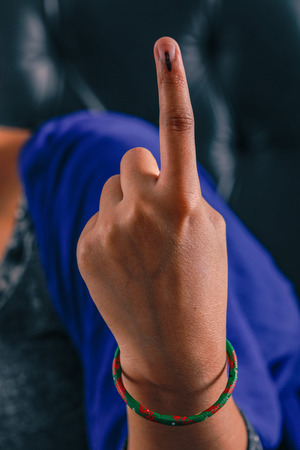 Indian Voter hand with voting sign after casting vote in electionの写真素材