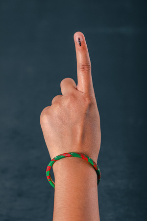 Indian Voter hand with voting sign after casting vote in electionの写真素材