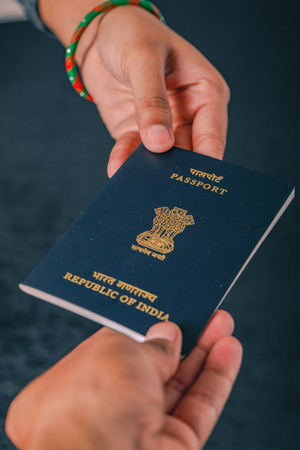 indian passport  in hand , showing passportの写真素材