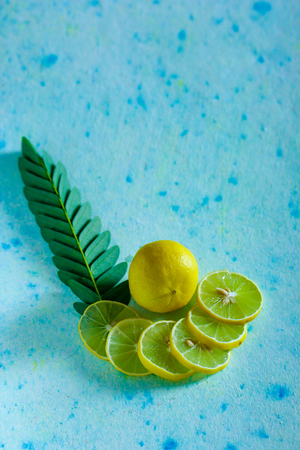 fresh yellow and green lemon on blue backgroundの写真素材