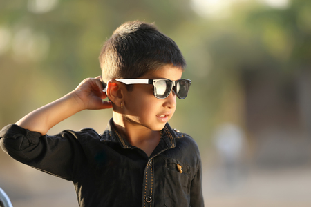 Cute Indian child wear sunglassesの写真素材