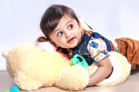 Cute Indian baby child playing with toyの写真素材