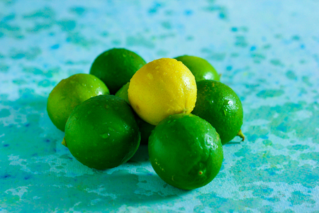 fresh yellow and green lemon on blue backgroundの写真素材