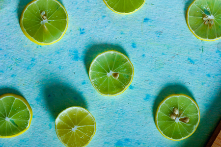 fresh yellow and green lemon on blue backgroundの写真素材