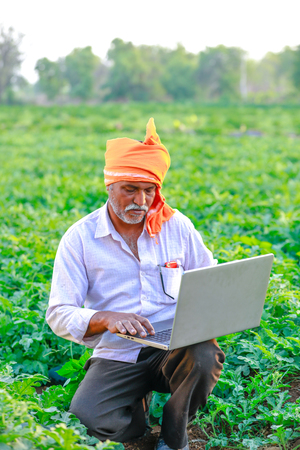 Indian rural farmer using laptopの写真素材