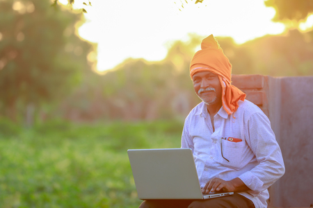 Indian rural farmer using laptopの写真素材