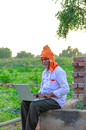 Indian rural farmer using laptopの写真素材