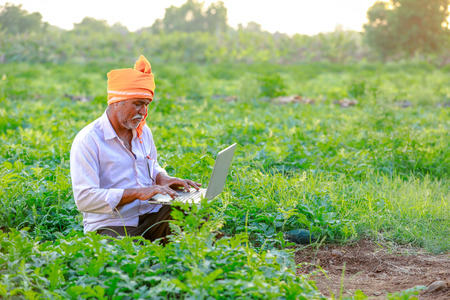 Indian rural farmer using laptopの写真素材