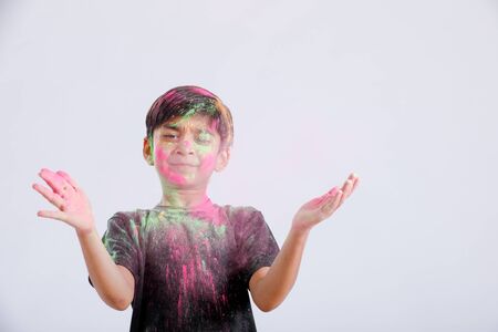 Indian little boy playing with the color and giving multiple expressions in holi festivalの写真素材