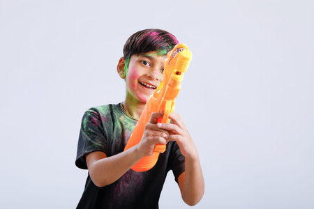 Indian Child playing holi with color gunの写真素材