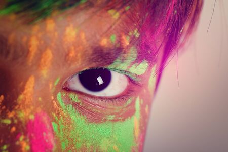 Indian little boy playing with the color and giving multiple expressions in holi festivalの写真素材