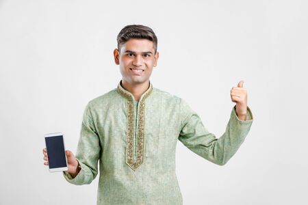 Young Indian Man In Ethnic wear and Showing Smartphoneの写真素材