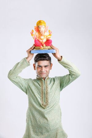 Young Indian man with Lord Ganesha , Celebrating Ganesh festivalの写真素材