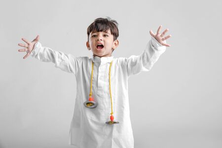 Indian Little Boy in Traditional Dress and learning Musical instrumentの写真素材