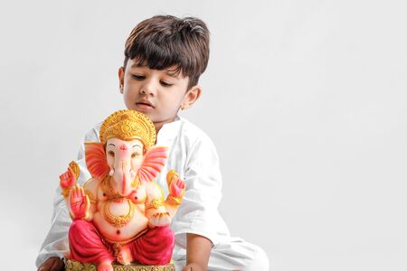 Little Indian boy with lord ganesha , Celebrating Ganesh Festivalの写真素材