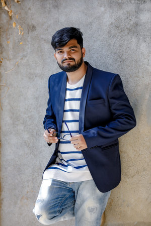 Handsome beard young man smiling and standing confidently