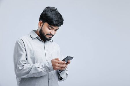 Young indian / Asian man using mobileの写真素材