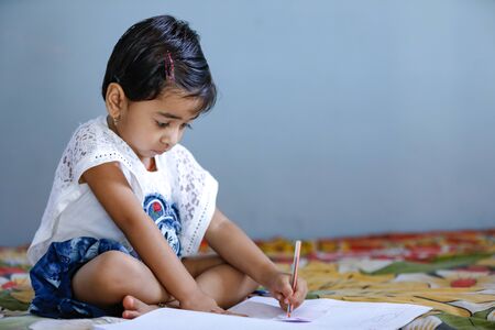 cute indian child studying at homeの写真素材
