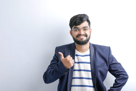 Indian / Asian young man showing thumbs up or ok signの写真素材