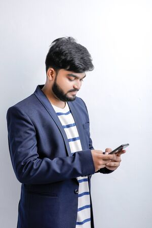 Young indian / Asian man using mobileの写真素材