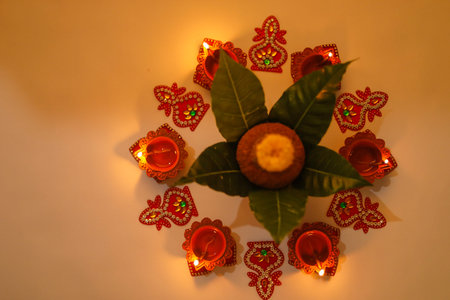 Copper Kalash with coconut , leaf and floral decoration on a white background. essential in hindu...