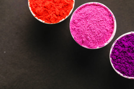Indian Festival Holi, Multi color's cup on dark background