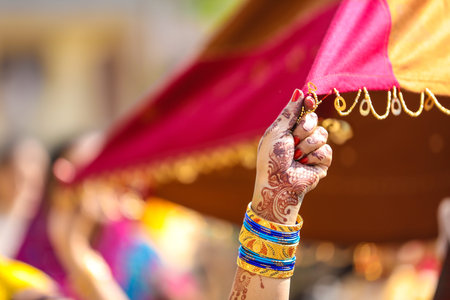 Indian wedding ceremony : bangle in bridal hand with mehandi design