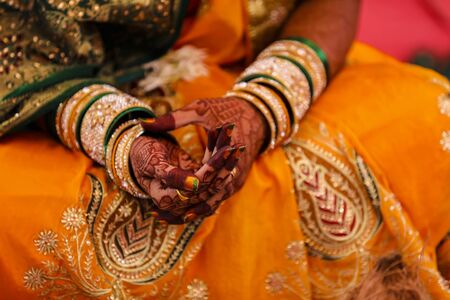 Indian wedding ceremony : bangle in bridal hand with mehandi designの写真素材