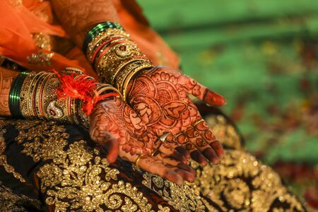 Indian wedding ceremony : bangle in bridal hand with mehandi designの写真素材