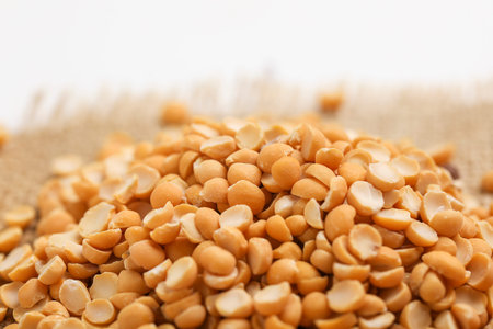 Dried chickpea lentils in wooden bowl on white background , Split Chickpea Also Know as Chana Dal
