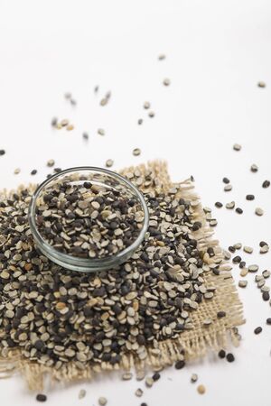 Split Black Lentil Also Know as Black Gram, Black Urad Dal, Vigna Mungo, Urad Beani glass bowl on white backgroundの写真素材