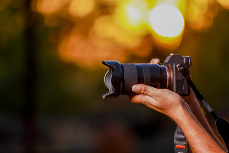 Jalgaon, Maharashtra / India - May 4, 2020 : Closeup of a black camera holding by Photographer's...