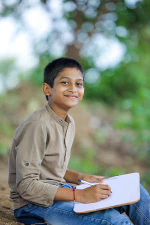 little Indian / Asian boy showing thumbs upの写真素材