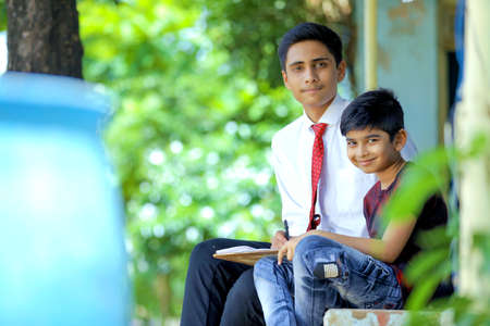 Two indian brother using laptop , Online education conceptの写真素材