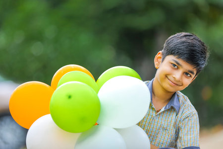 cute little indian boy with tri color balloons and celebrating Independence or Republic day of India