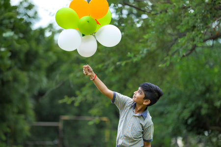 cute little indian boy with tri color balloons and celebrating Independence or Republic day of India