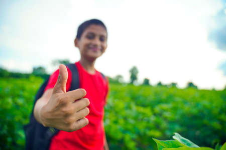 little Indian / Asian boy showing thumbs up , selective focus on handの写真素材